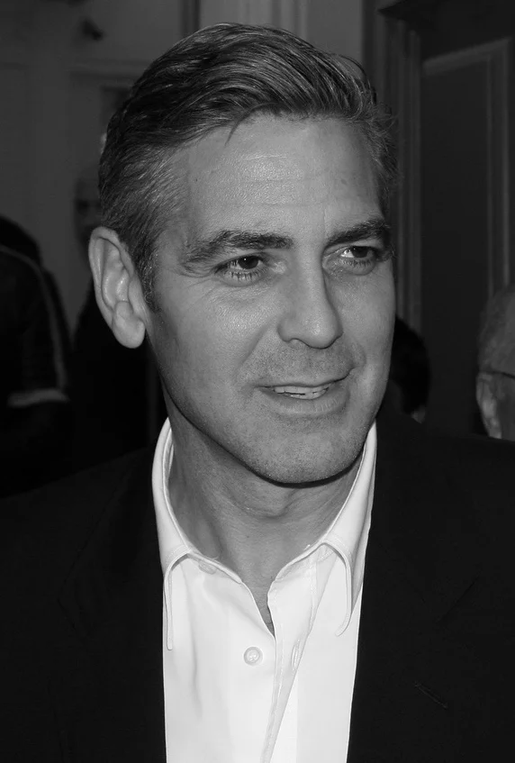 George Clooney photographed in a black-and-white portrait in 2007. Licensed image; it identifies the person only and is not evidence of any dental treatment.