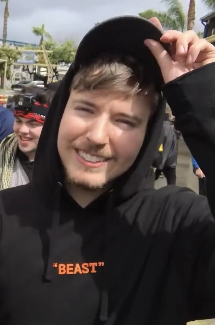 MrBeast photographed outdoors wearing a hooded top in 2019. Licensed image; it identifies the person only and is not evidence of any dental treatment.